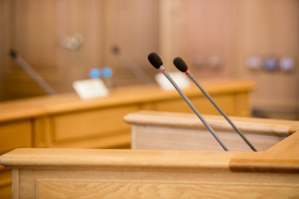 istock before a conference, the microphones in front of empty chairs. 1143654060