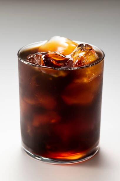 Pour iced coffee into a glass
