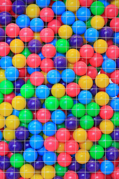 istock Colorful plastic balls in cage on children's playground. 1143655341