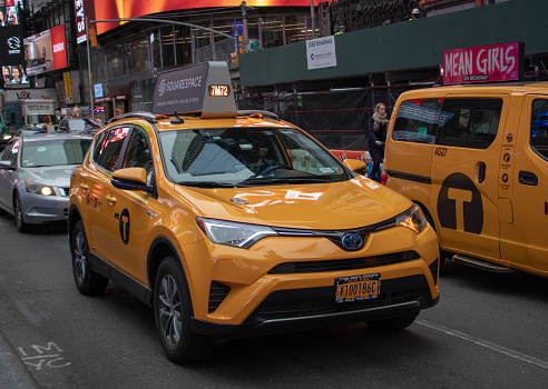 New York USA, 8th April 2019: A United States of America yellow Taxi traveling on a road in New York City