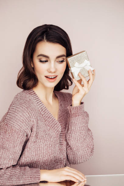 istock Beautiful woman holding a present 1143658421