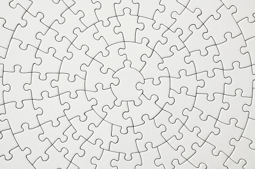 Close-up and overhead shot of blank circle jigsaw puzzle texture background.
