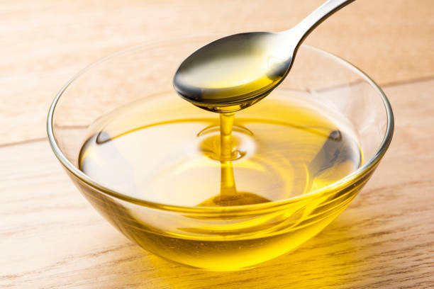 istock Scoop olive oil with a spoon 1143659760