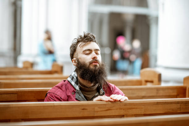 istock Man praying in the church 1143661883