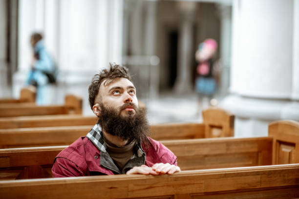 istock Man praying in the church 1143661918