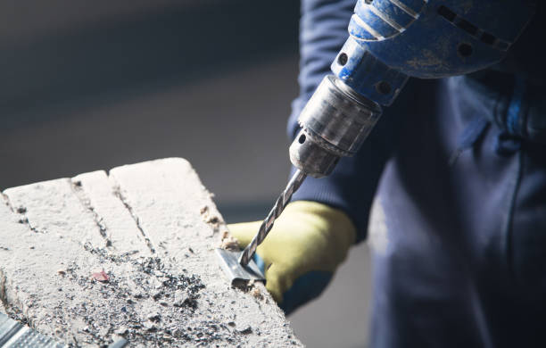 istock Master drills a hole in a metal. Industry 1143662610