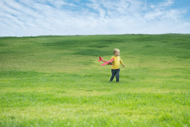 istock A boy plays in a toy red plane 1143665875