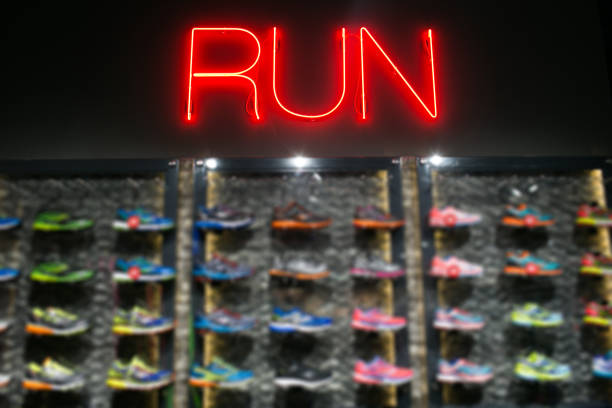 Trendy casual running shoes on dark background. Run, colorful poster