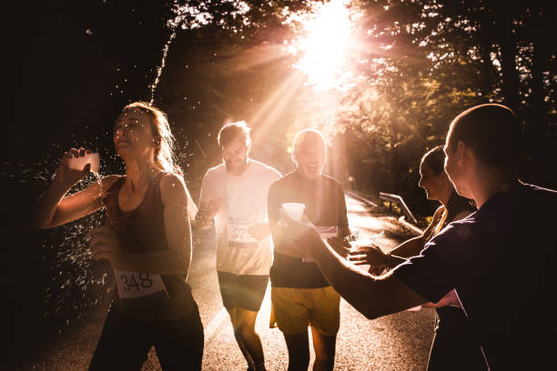 istock Group of athletes refreshing themselves with water during marathon race. 1143665978