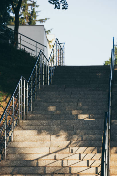 istock Empty concrete stairs with stainless steel handrails. 1143665996