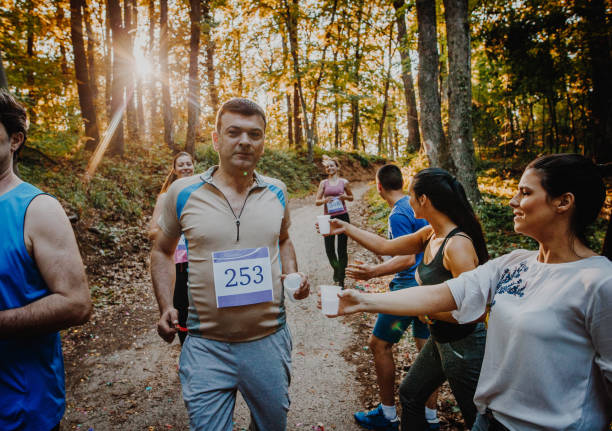 istock Group of runners refreshing themselves during marathon race. 1143666051