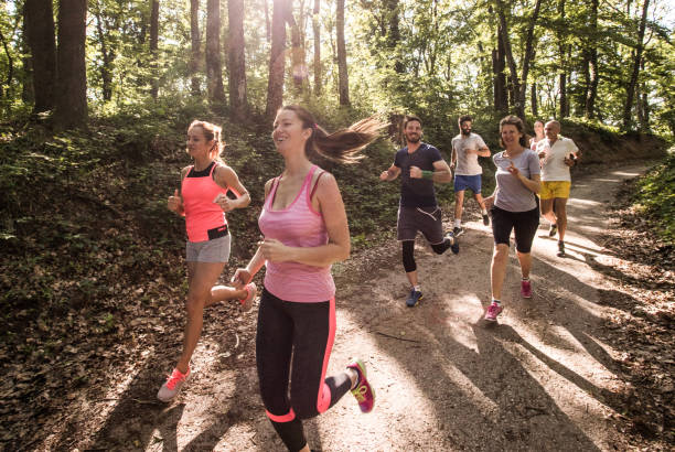 istock Large group of marathon racers running through the forest. 1143666751