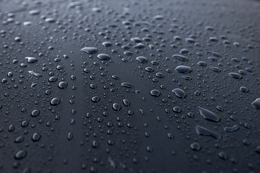 Water drops close up on a waterproof surface.ater-repellent material