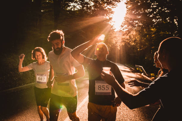 istock Marathon runner refreshing himself while pouring water on his head during a race at sunset. 1143674547