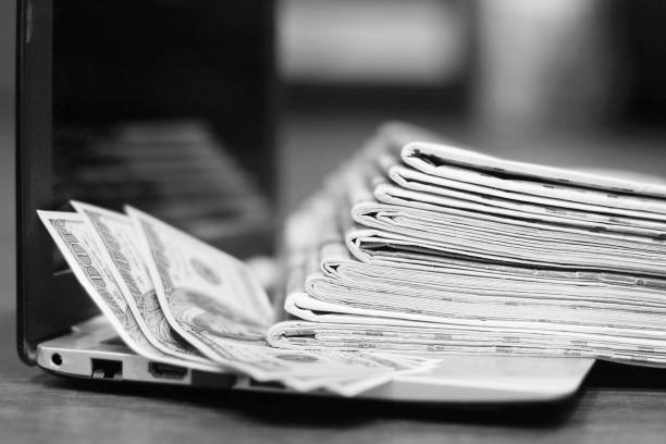 istock Newspapers, Laptop and Money 1143675583