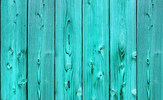 Close up shot of vertical turquoise fence wood panel texture