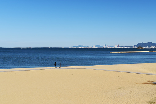 From Momochi area took the sea at Hakata bay. Here is tourist spot, there are hotel, stadium, shopping mall at the back of the sea, Fukuoka, Japan November 2018.