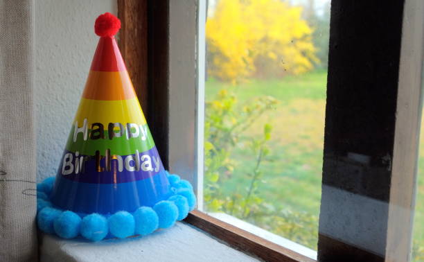 colourfull glitter hat on windowsill with green grass outside colourfull glitter hat on windowsill with green grass outside dutch happy end stock pictures, royalty-free photos & images