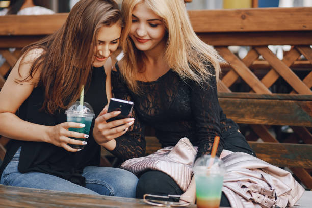 istock girls with phone 1143686022