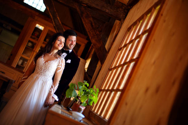 istock Beautiful wedding couple posing on window 1143686091