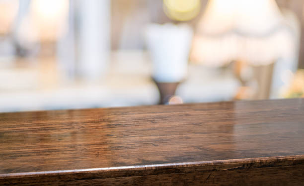 wood table at restaurant blur background.Empty perspective hardwood bar with blur coffee shop with bokeh light,Mock up for display or montage of product,Banner or header for advertise on online media stock photo
