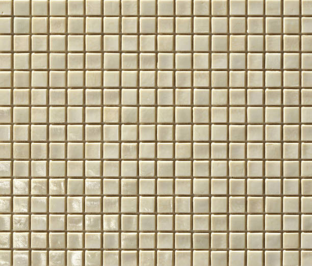 istock Beige ceramic mosaic tiles texture background with reflections. 1143688255