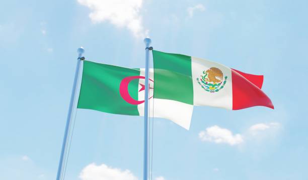 istock Mexico and Algeria, two flags waving against blue sky 1143690056