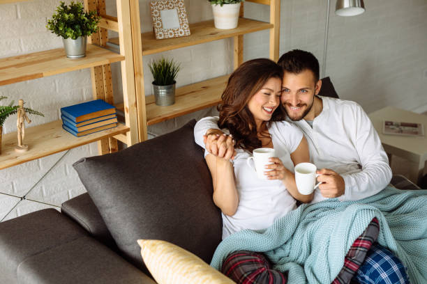 istock Loving couple relaxing on a sofa 1143690846