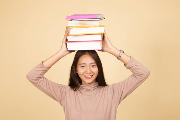 istock Young Asian woman studying  with may books. 1143690994