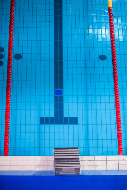 Empty swimming pool with swimming lane markers ready for competition. Shot from above.