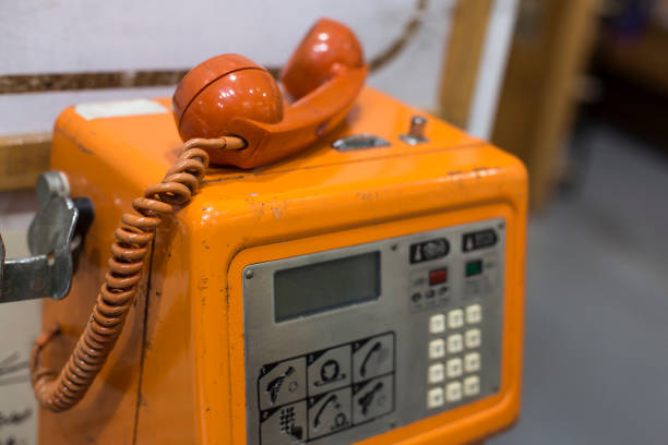 telephone on porch wall with old and new tools in the background