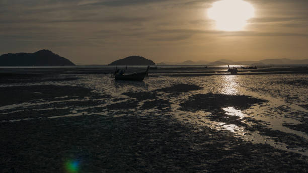 istock Thai coastline with fishing boat 1143696384