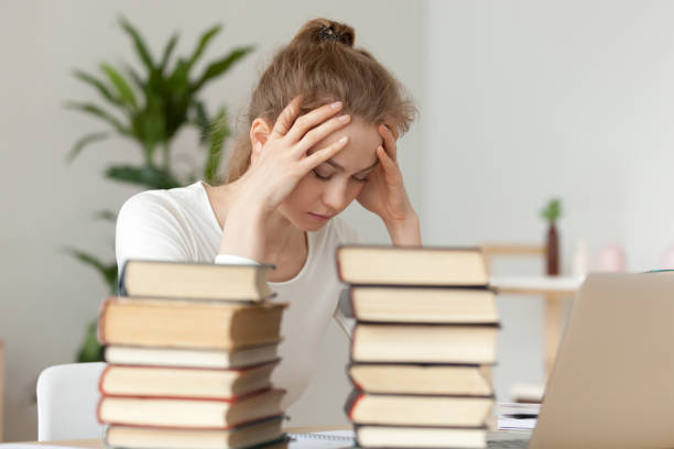 istock Upset woman sitting with closed eyes, annoyed by learning 1143696613