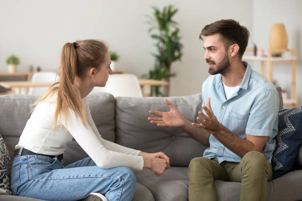 istock Serious young couple sitting together, talking about relationships 1143696716