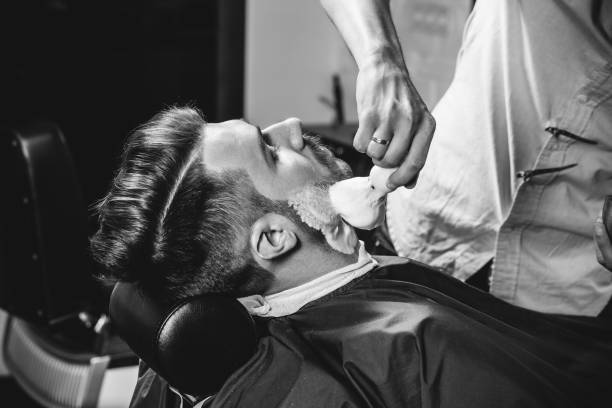 istock Client during beard shaving at barbershop. 1143697848