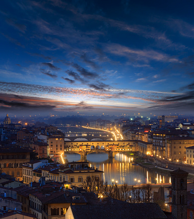 Evening twilight sky with clouds above Florence, Italy, Tuscany. City top view and bridges across Arno river.