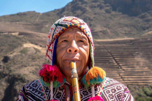istock Senior man dressing traditional peruvian clothing and playing flute 1143698259