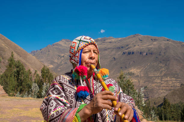 istock Senior man dressing traditional peruvian clothing and playing flute 1143698270