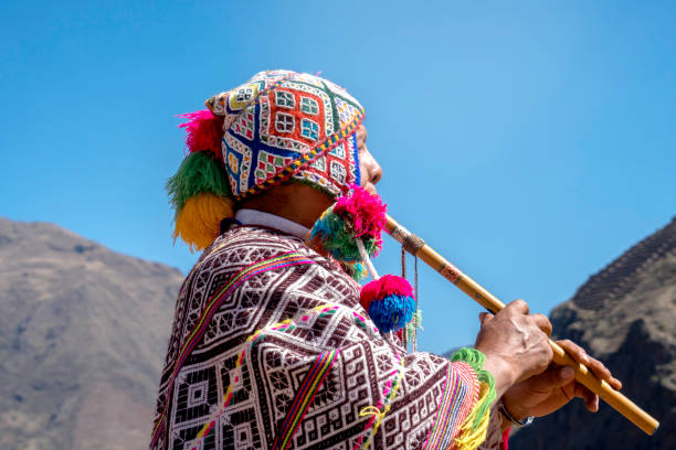 istock Senior man dressing traditional peruvian clothing and playing flute 1143698281