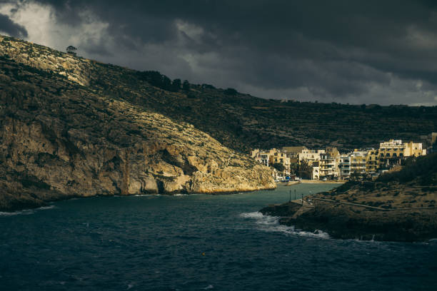 rocky coastline with town panorama. sunset - travel destinations rocky coastline moody sky clear sky imagens e fotografias de stock