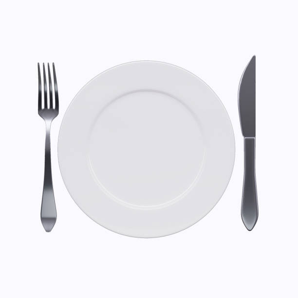 istock White plate with fork and knife, isolated on white background. Top view 1143700993