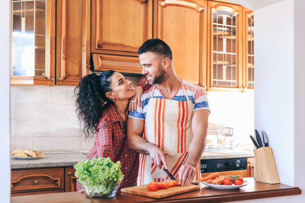 istock Couple in love preparing dinner at home 1143701112
