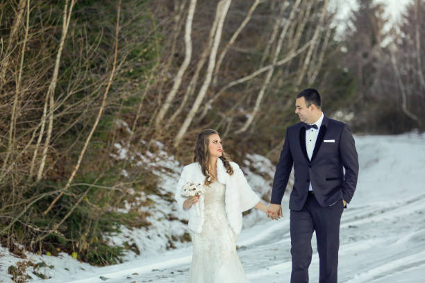 istock Beautiful wedding couple posing on winter time 1143701223