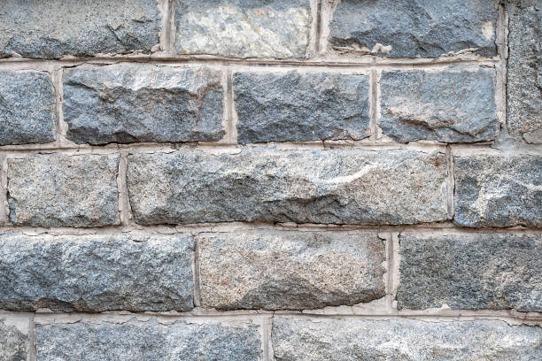 istock A wall of rough granite bricks with cement grout between them 1143701827