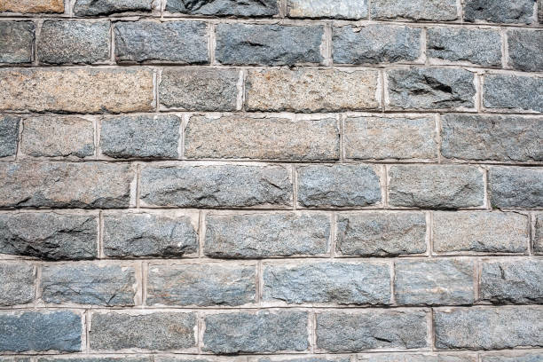 istock A wall of rough granite bricks with cement grout between them 1143701857