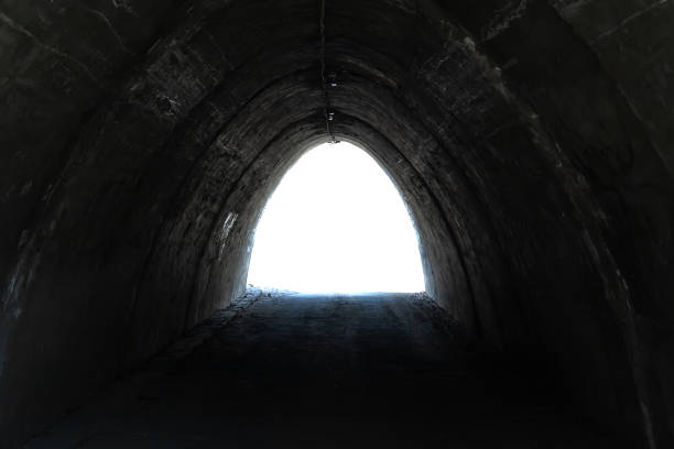 istock View from the dark rough tunnel on the white isolated background 1143701968