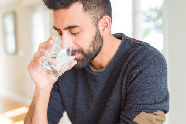 istock Handsome man drinking a fresh glass of water 1143702150