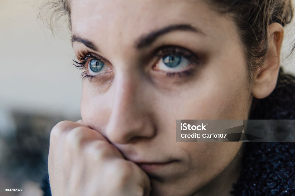 Troubled Emotions Portrait of beautiful thoughtful young woman with blue eyes Insanity Stock Photo