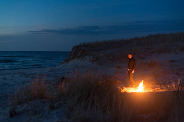 istock Beach camp and bonfire at night. Nature retreat 1143703131