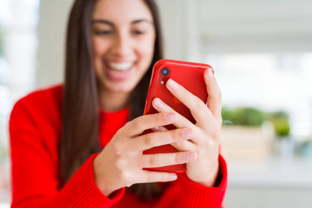 istock Young woman using smartphone, smiling happy texting and typing 1143703436